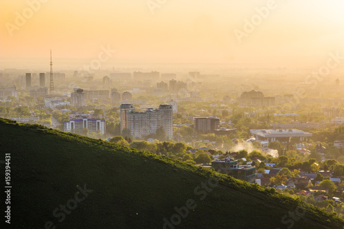 Almaty city in the fog in sunset with smog and dust in the air, Kazakhstan