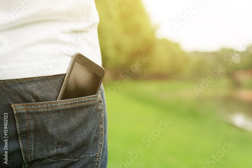 Smartphone in back pocket of a man's jeans