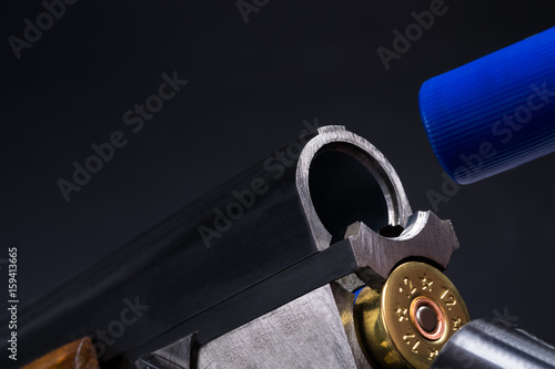 Shotgun with cartridges on a black background