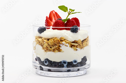 Glass jar of Greek yogurt isolated on white background from side view.