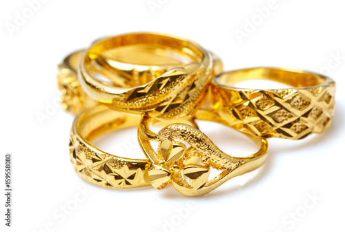 Group of many design gold rings on white background