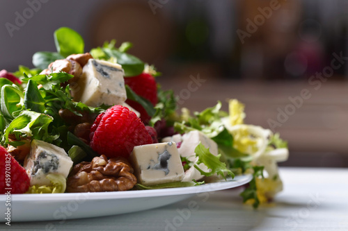 Green salad with blue cheese , raspberry and nuts