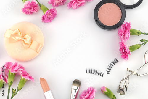 Cosmetic decorated with pink carnation flowers on white background with copy space