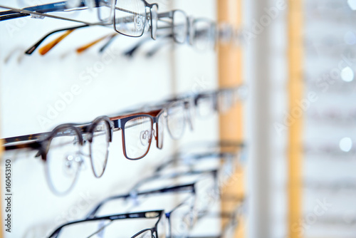 in optician shop- different glasses for sale in wall rack