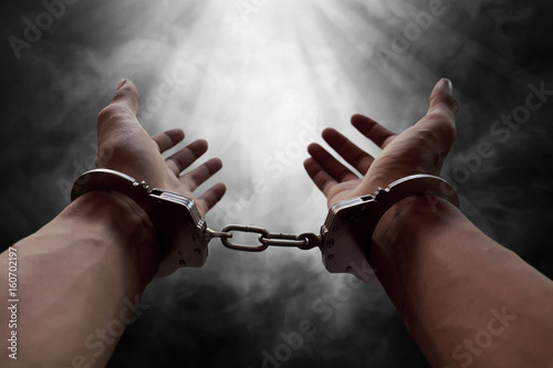 Hands of prisoner in handcuffs