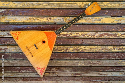 Musical instrument balalaika on wooden background