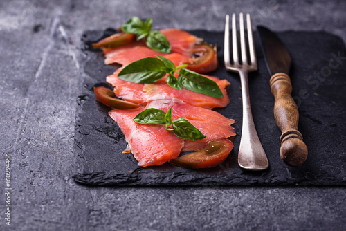 Salmon carpaccio with basil and tomato
