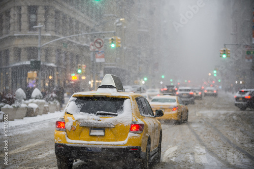 A winter snowstorm brings traffic and pedestrians to a slow crawl at the Flatiron Building on Fifth Avenue. 