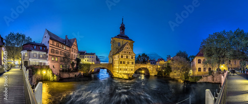 Bamberg. Panoramic view of Old Town Hall of Bamberg (Altes Rathaus) with two bridges over the Regnitz river in the evening, Germany