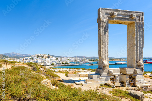 The Portara, one of Naxos most famous landmarks connected to Naxos (Chora) town by a causeway. Cyclades Islands, Greece. 