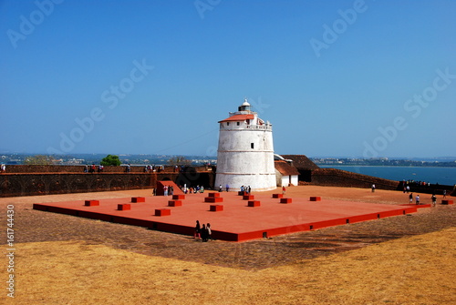 The lighthouse of the Aguada Fort in Candolim, Goa, India overlooking the Arabian Sea