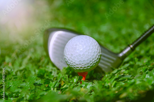 Golf club and ball in grass. The Golf club with golf ball close up in grass field.