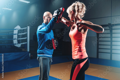 Woman on self defense training with male trainer