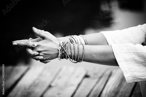 woman hands in yoga symbolic gesture mudra bw