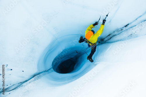 Ice flying from an ice ax swing while on lead out of a moulin on the Matanuska Glacier, Alaska
