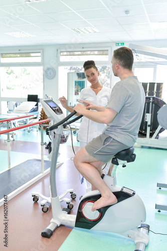 patient having physiotherapy on exercise bike in hospital