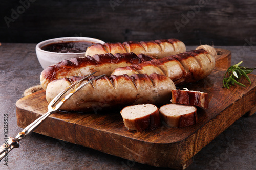 Grilled sausages with sauce ketchup on a wooden table - Home-made Pork Sausages