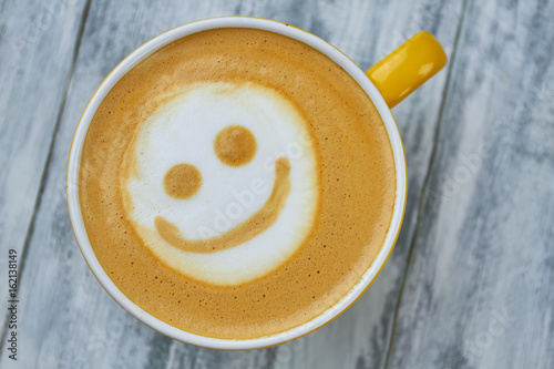 Latte art smiley face. Top view of coffee. Surprising facts about caffeine.