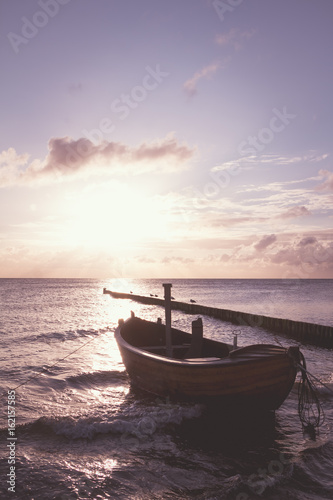 Coastline with a special dreamy mood on the beach with a wooden boat
