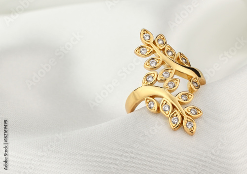 jewelry ring with diamonds on white cloth, soft focus