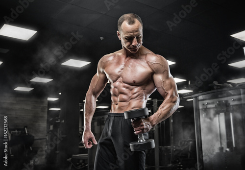 Brutal bodybuilder athletic man with six pack, perfect abs, shoulders, biceps, triceps and chestBrutal bodybuilder athletic man with six pack, perfect abs, shoulders, biceps, triceps and chest