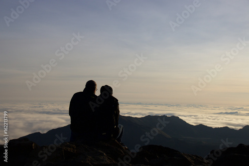 Couple at Haleakala summit watching sunrise