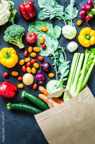 Colorful organic vegetables in paper eco shopping bag