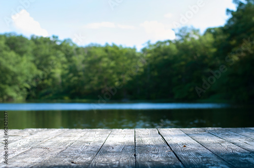 Beautiful forest and lake with a wooden board.