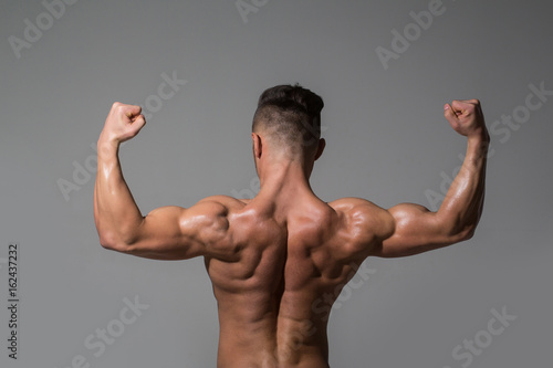 biceps and triceps of athlete with muscular body