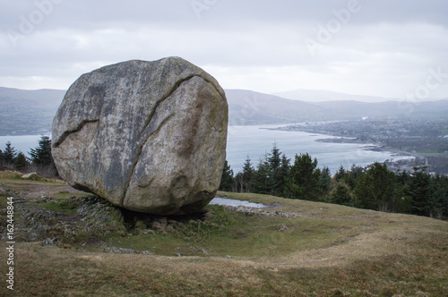 Glacial erratic with a bay in the distance