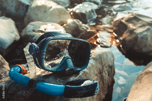 Mask For Freediving And Snorkel Lie On The Beach, On The Rocks, Closeup. Tourism And Travel Concept