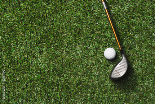 top view of golf club and ball on grass field