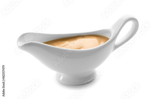 Sauce boat with turkey gravy on white background