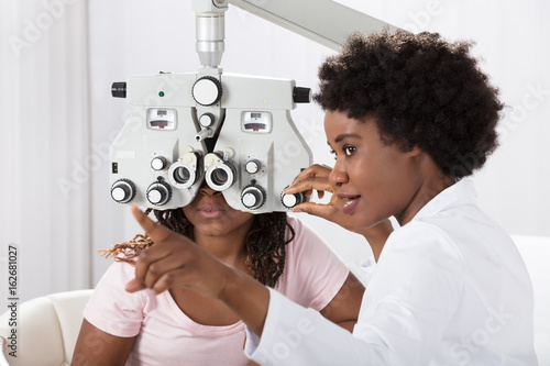 Optometrist Doing Sight Testing For Patient