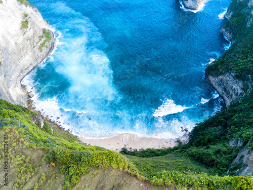 Aerial view of Paluang cliff and the beach below it near Klingking beach on Nusa Penida, Bali, Indonesia.