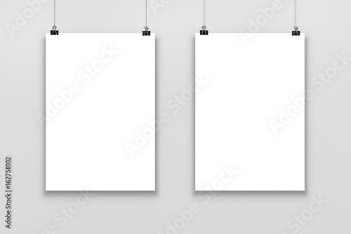 Two Blank paper poster mockup isolated on a gray background. 