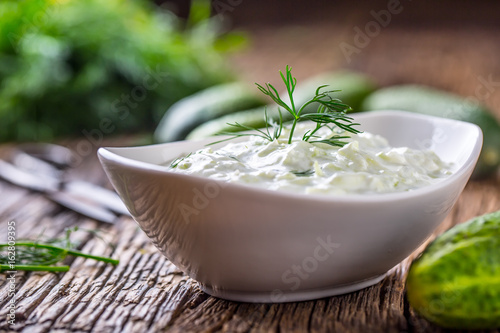 Tzatziki. Traditional greek dip sauce or dressing tzatziki prepared with grated cucumber sour cream yogurt olive oil and fresh dill. Mediterranean cuisine.