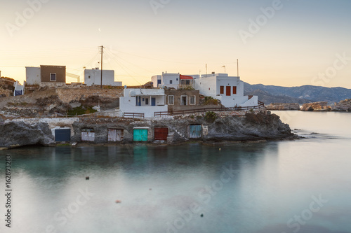 Boat houses in fishing village of Goupa on Kimolos island in Greece. 