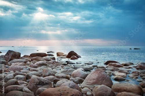 Rocky shores at the sea in sunset light. Lahemaa natural park coastal landscape with beautiful sky