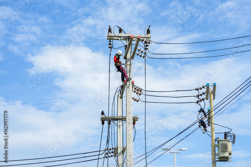 Electrician work installation of high voltage in high voltage stations safely and systematically over clear sky natural background.