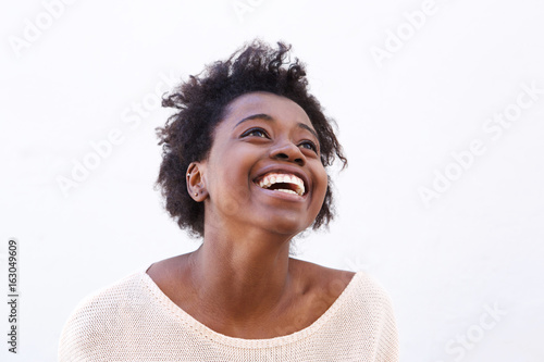 Young black woman looking up and laughing