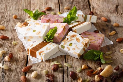 French fresh nougat with nuts and pumpkin seeds close-up. horizontal
