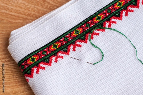 Fragment of embroidery on the canvas with a needle