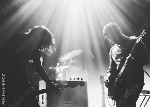 Rock band on a stage in a backlights