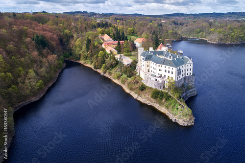 Aerial view on czech romantic, gothic chateâu Orlik, situated on rock outcrop above Orlik reservoir in beautiful spring nature. Romantic,royal Schwarzenberg castle above water level. Czech landscape.