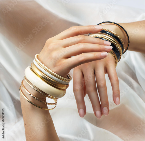 Girl’s hands with golden bracelets