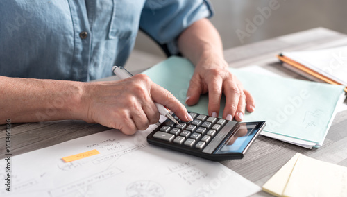 Female accountant using calculator
