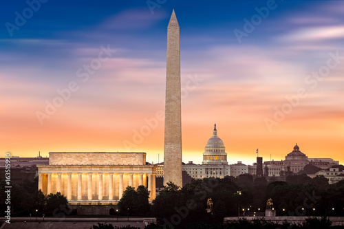 Dawn over Washington - with 3 iconic monuments illuminated at sunrise: Lincoln Memorial, Washington Monument and the Capitol Building.