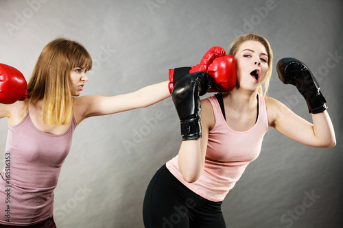 Agressive women fighting boxing with female