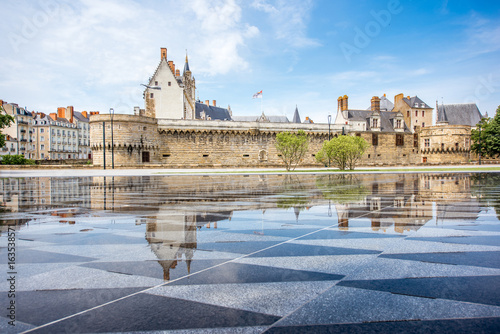 View on the castle of Dukes of Brittany with water mirror fountain in Nantes city in France